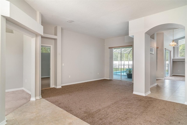 14266 Creek Run Dr, Riverview, FL 33579 - unfurnished living room with carpet flooring, arched walkways, and healthy amount of natural light