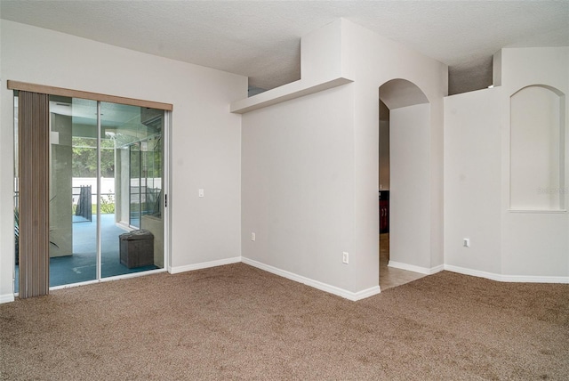 14266 Creek Run Dr, Riverview, FL 33579 - unfurnished room with carpet, baseboards, arched walkways, and a textured ceiling
