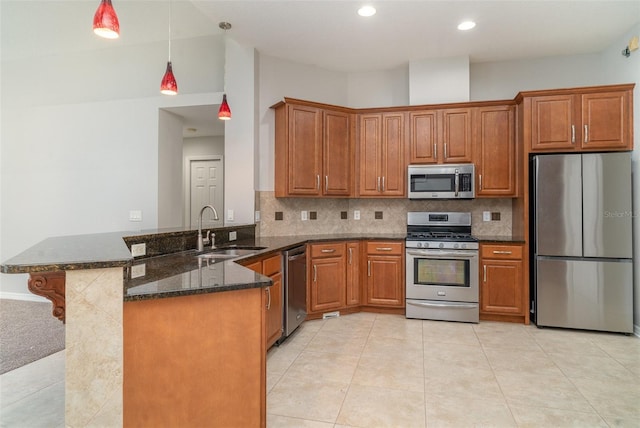 14266 Creek Run Dr, Riverview, FL 33579 - kitchen with appliances with stainless steel finishes, a sink, a peninsula, brown cabinetry, and recessed lighting