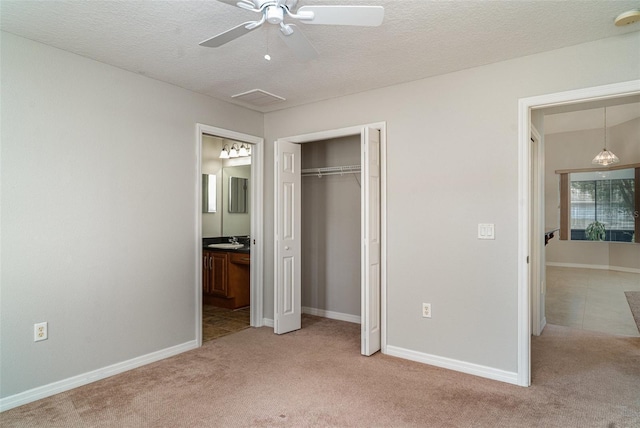 14266 Creek Run Dr, Riverview, FL 33579 - unfurnished bedroom featuring a sink, light carpet, a closet, baseboards, and a textured ceiling