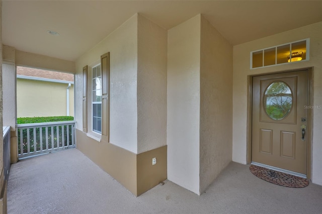 2128 Worthington Greens Dr, Sun City Center, FL 33573 - property entrance with stucco siding and a porch