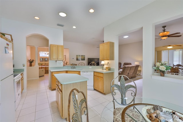 2128 Worthington Greens Dr, Sun City Center, FL 33573 - kitchen featuring white appliances, light brown cabinets, light countertops, a sink, and a kitchen island