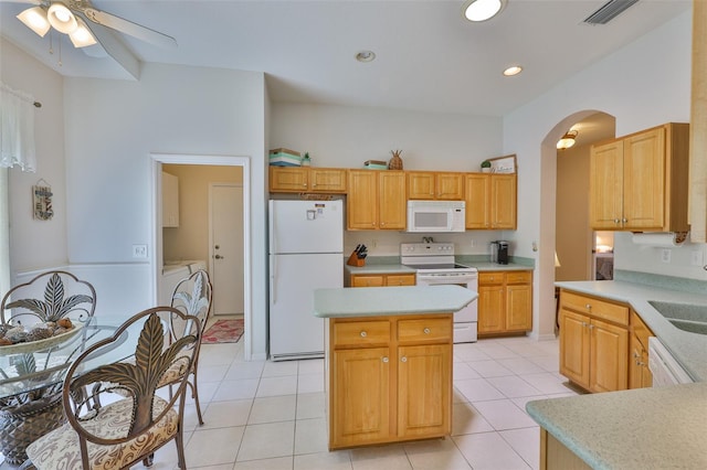 2128 Worthington Greens Dr, Sun City Center, FL 33573 - kitchen featuring white appliances, independent washer and dryer, arched walkways, a ceiling fan, and light countertops