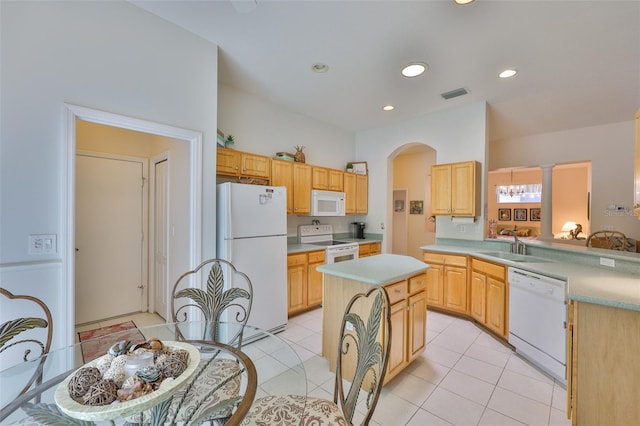 2128 Worthington Greens Dr, Sun City Center, FL 33573 - kitchen featuring white appliances, a sink, light countertops, arched walkways, and light brown cabinetry