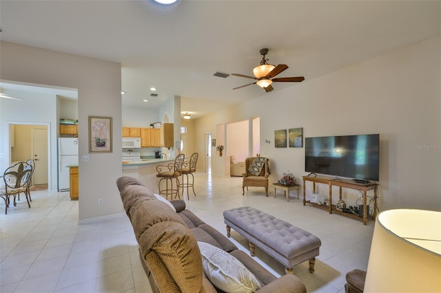 2128 Worthington Greens Dr, Sun City Center, FL 33573 - living area with a ceiling fan, light tile patterned floors, and baseboards
