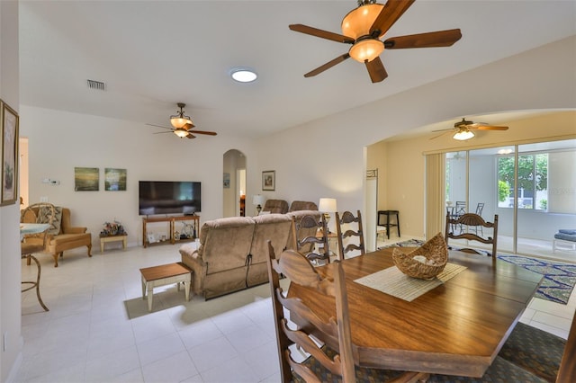 2128 Worthington Greens Dr, Sun City Center, FL 33573 - dining room featuring arched walkways, a ceiling fan, and light tile patterned floors