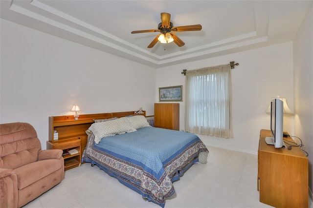 2128 Worthington Greens Dr, Sun City Center, FL 33573 - bedroom with a tray ceiling, baseboards, ceiling fan, and light tile patterned floors