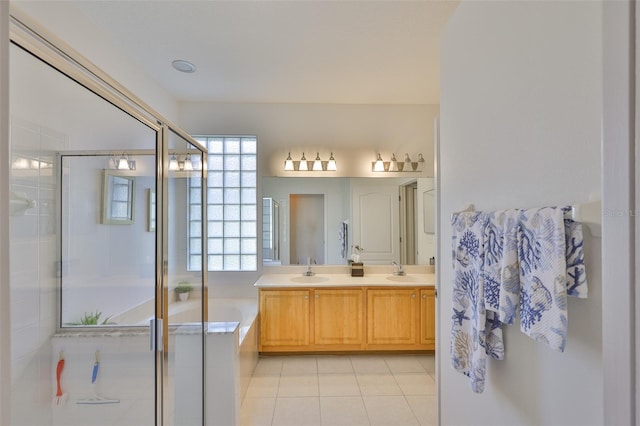 2128 Worthington Greens Dr, Sun City Center, FL 33573 - bathroom with double vanity, a bath, a stall shower, and tile patterned flooring