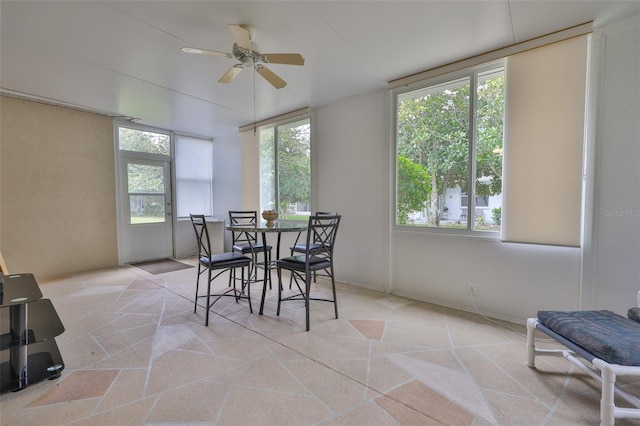 2128 Worthington Greens Dr, Sun City Center, FL 33573 - dining space with a ceiling fan and light stone finish floors