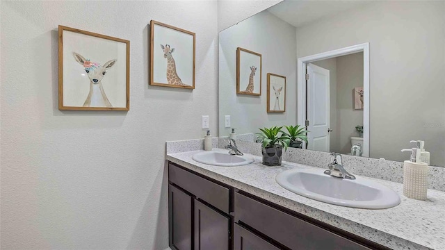 1704 Tahitian Sunrise Dr, Plant City, FL 33565 - bathroom with double vanity, toilet, and a textured wall