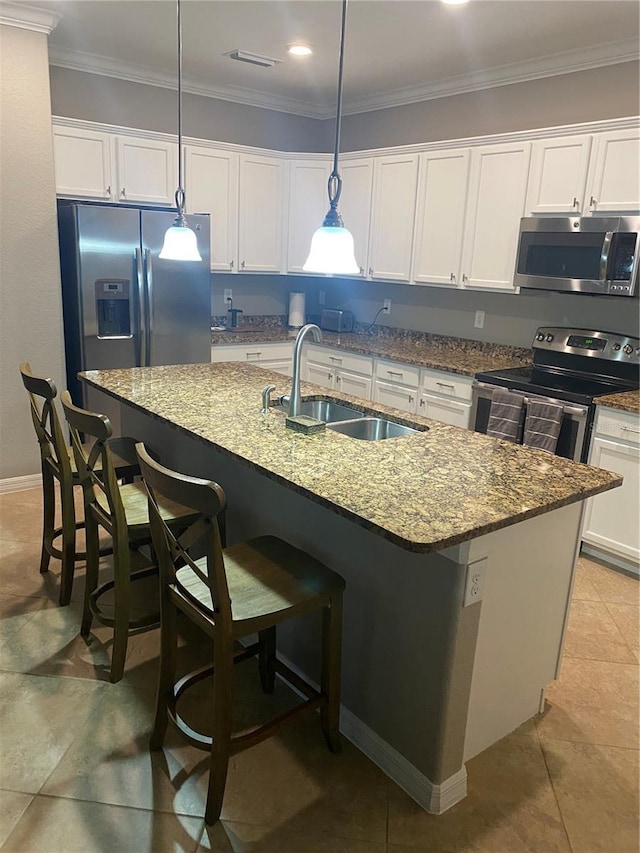 12619 Richezza Dr, Venice, FL 34293 - kitchen with stainless steel appliances, a sink, white cabinets, and ornamental molding