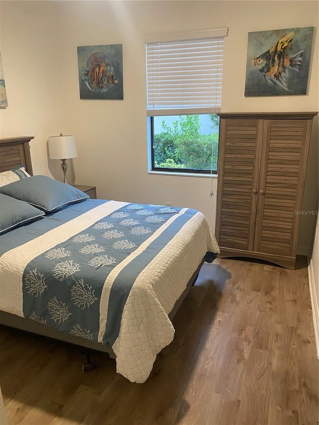 12619 Richezza Dr, Venice, FL 34293 - bedroom featuring wood finished floors
