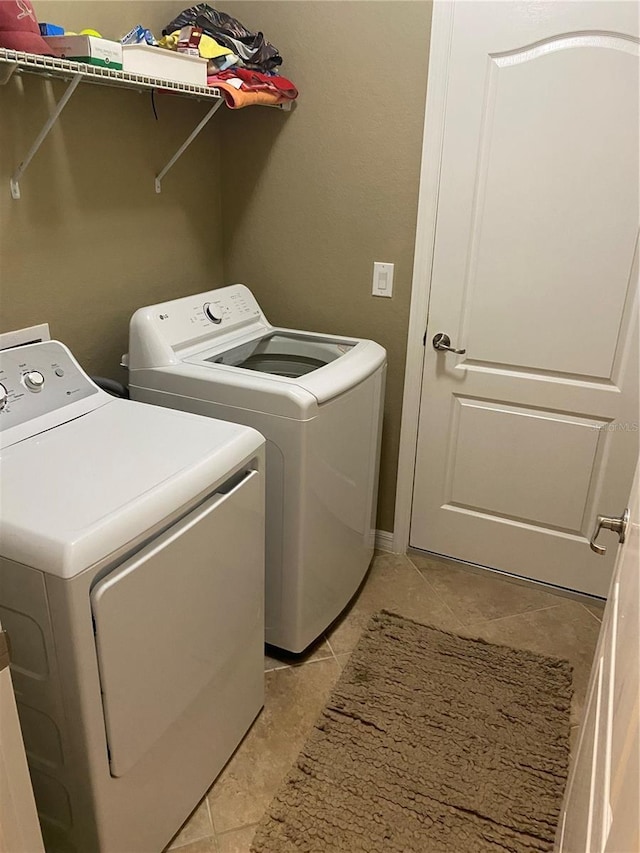 12619 Richezza Dr, Venice, FL 34293 - laundry area featuring washing machine and dryer and light tile patterned floors
