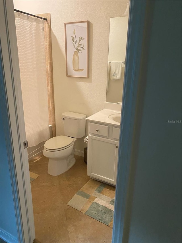 12619 Richezza Dr, Venice, FL 34293 - full bath featuring toilet, vanity, shower / bath combo with shower curtain, and tile patterned flooring