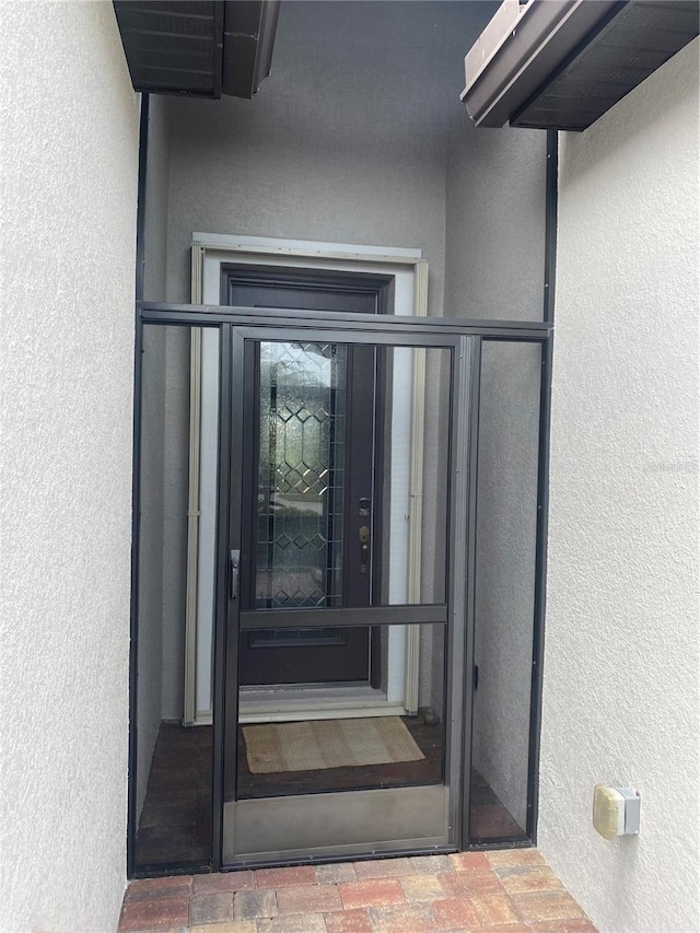 12619 Richezza Dr, Venice, FL 34293 - doorway to property with stucco siding