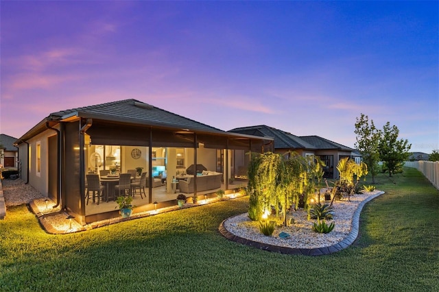 31921 Magna Gulf Loop, San Antonio, FL 33576 - back of property at dusk featuring a patio and a tiled roof