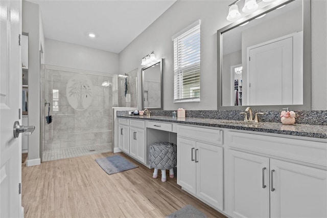 31921 Magna Gulf Loop, San Antonio, FL 33576 - full bathroom featuring double vanity, a shower stall, wood finished floors, and recessed lighting