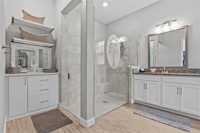 31921 Magna Gulf Loop, San Antonio, FL 33576 - bathroom featuring vanity, wood finished floors, and walk in shower