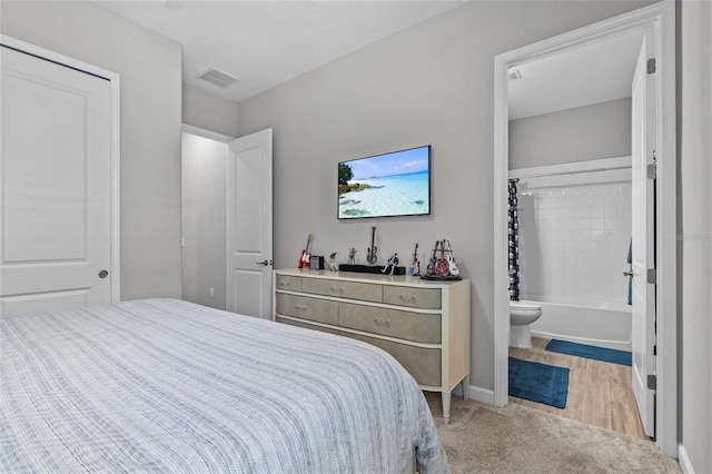 31921 Magna Gulf Loop, San Antonio, FL 33576 - bedroom featuring light carpet, ensuite bathroom, and baseboards