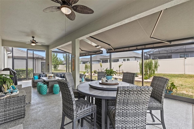31921 Magna Gulf Loop, San Antonio, FL 33576 - sunroom / solarium with ceiling fan, outdoor dining space, and an outdoor hangout area