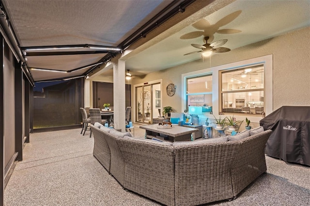 31921 Magna Gulf Loop, San Antonio, FL 33576 - living area featuring a textured wall, carpet flooring, and a ceiling fan