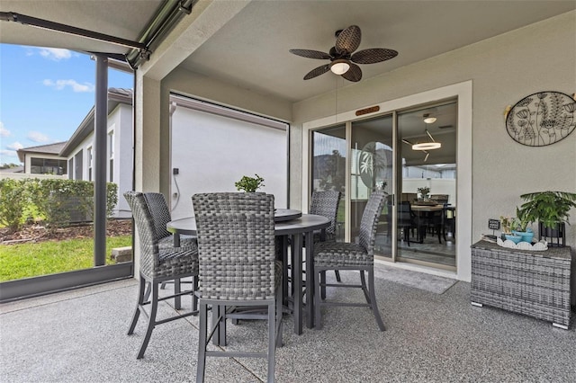 31921 Magna Gulf Loop, San Antonio, FL 33576 - sunroom with outdoor dining space, ceiling fan, and carpet