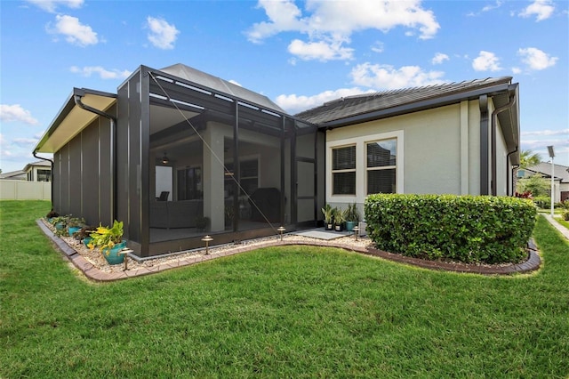 31921 Magna Gulf Loop, San Antonio, FL 33576 - back of house with a yard, stucco siding, and a lanai