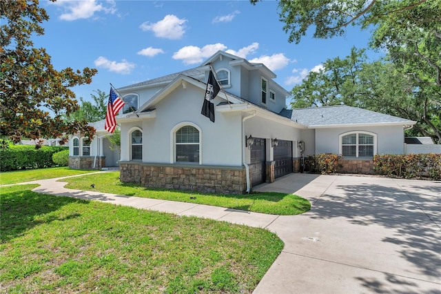 2011 Water Wheel Ct, Dunedin, FL 34698 - traditional home featuring stucco siding, stone siding, concrete driveway, and a front yard