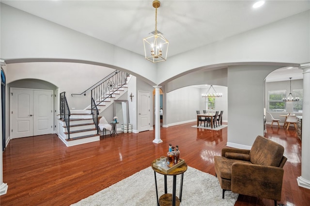 2011 Water Wheel Ct, Dunedin, FL 34698 - living room featuring a chandelier, wood finished floors, arched walkways, stairway, and recessed lighting