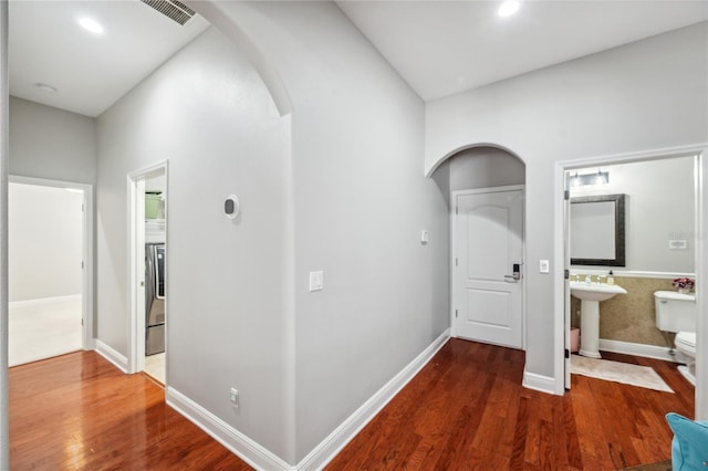 2011 Water Wheel Ct, Dunedin, FL 34698 - corridor featuring arched walkways, wood finished floors, baseboards, a sink, and recessed lighting