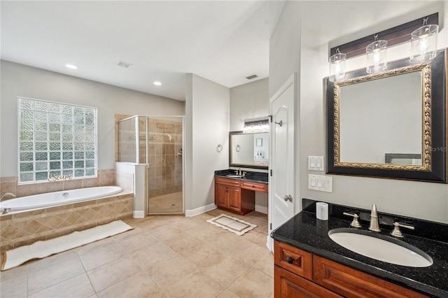 2011 Water Wheel Ct, Dunedin, FL 34698 - full bath featuring a stall shower, tile patterned flooring, a garden tub, two vanities, and recessed lighting