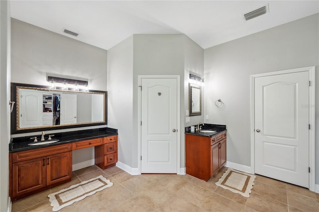 2011 Water Wheel Ct, Dunedin, FL 34698 - bathroom featuring two vanities, baseboards, tile patterned flooring, and a closet
