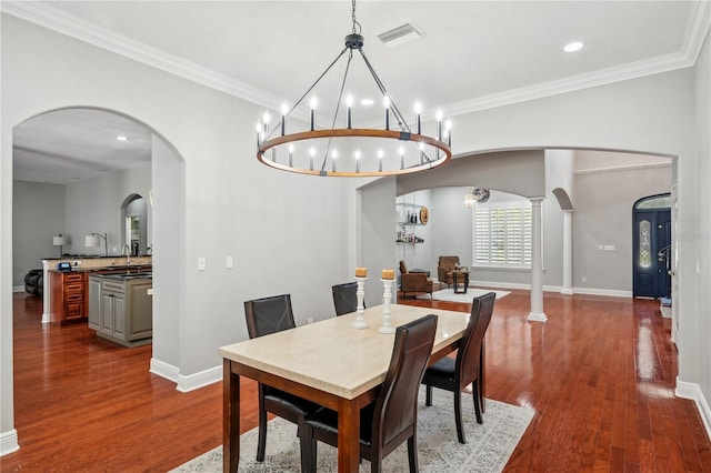 2011 Water Wheel Ct, Dunedin, FL 34698 - dining room featuring arched walkways, dark wood-type flooring, baseboards, ornamental molding, and recessed lighting
