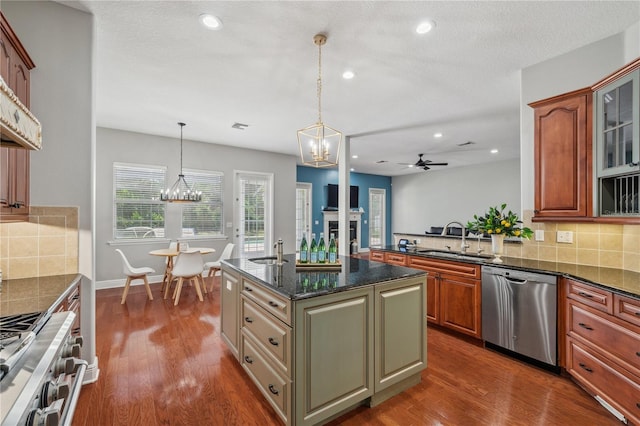2011 Water Wheel Ct, Dunedin, FL 34698 - kitchen featuring stainless steel appliances, a sink, a chandelier, a ceiling fan, and decorative backsplash