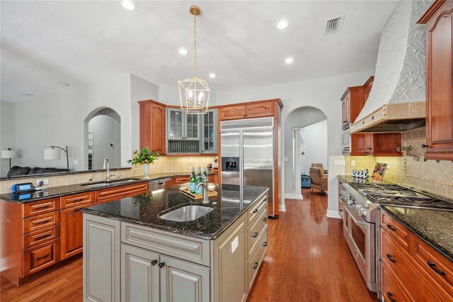 2011 Water Wheel Ct, Dunedin, FL 34698 - kitchen featuring arched walkways, a sink, high end appliances, and recessed lighting