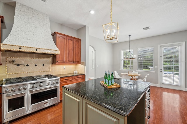 2011 Water Wheel Ct, Dunedin, FL 34698 - kitchen featuring double oven range, a chandelier, premium range hood, wood finished floors, and recessed lighting