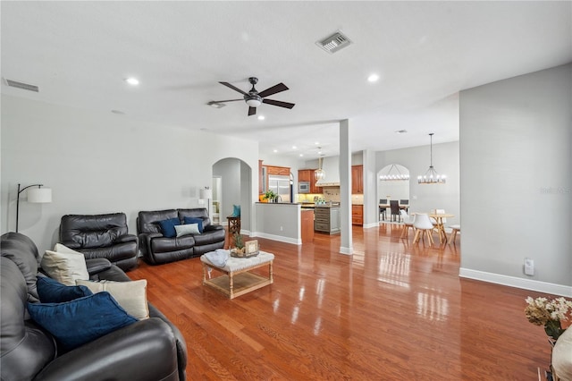 2011 Water Wheel Ct, Dunedin, FL 34698 - living area featuring arched walkways, light wood-type flooring, recessed lighting, a ceiling fan, and baseboards