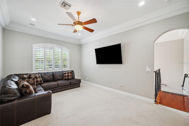2011 Water Wheel Ct, Dunedin, FL 34698 - carpeted living room featuring arched walkways, crown molding, ceiling fan, recessed lighting, and baseboards