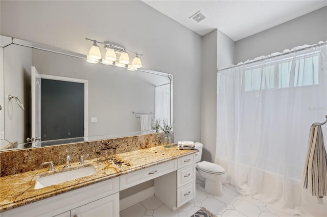 2011 Water Wheel Ct, Dunedin, FL 34698 - bathroom featuring vanity, toilet, shower / bath combo, and tile patterned flooring