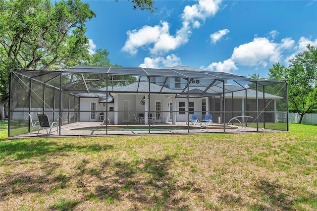 2011 Water Wheel Ct, Dunedin, FL 34698 - rear view of house featuring a patio, a yard, an outdoor pool, and glass enclosure