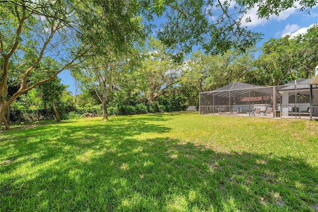 2011 Water Wheel Ct, Dunedin, FL 34698 - view of grassy yard featuring glass enclosure