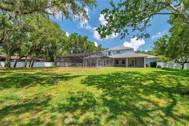 2011 Water Wheel Ct, Dunedin, FL 34698 - view of yard with glass enclosure and ceiling fan