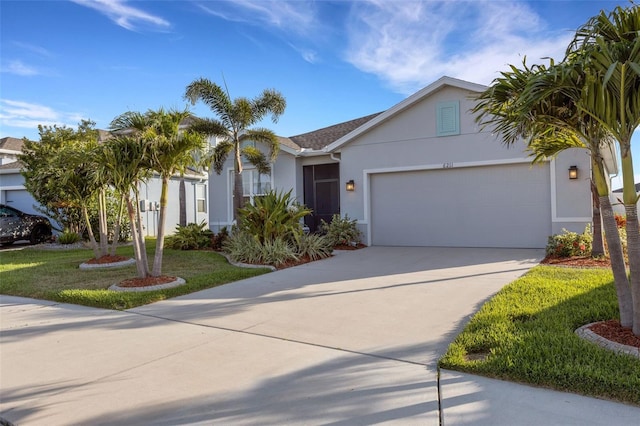 6211 114th Dr E, Parrish, FL 34219 - view of front of property with stucco siding, driveway, an attached garage, and a front lawn