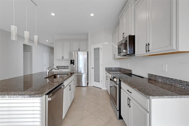 6211 114th Dr E, Parrish, FL 34219 - kitchen with appliances with stainless steel finishes, a sink, white cabinetry, an island with sink, and recessed lighting