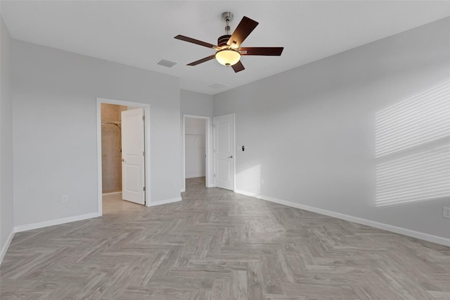 6211 114th Dr E, Parrish, FL 34219 - unfurnished bedroom with a spacious closet, baseboards, ceiling fan, and a closet
