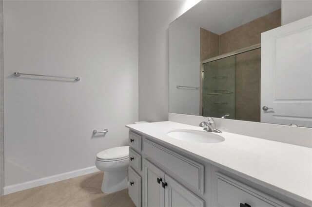 6211 114th Dr E, Parrish, FL 34219 - full bathroom with vanity, a stall shower, toilet, tile patterned flooring, and baseboards