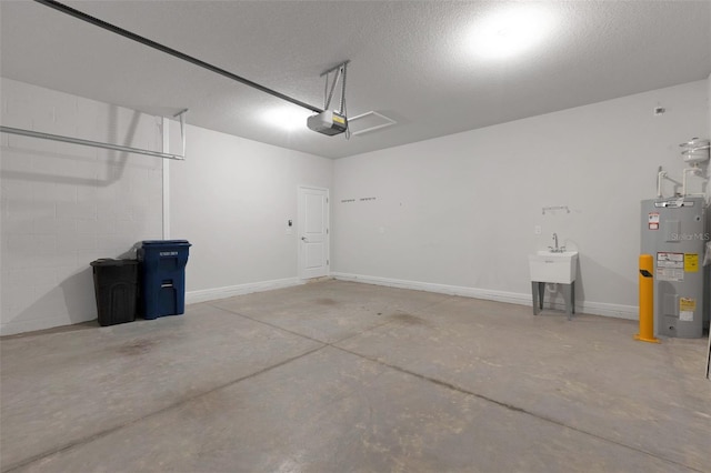 6211 114th Dr E, Parrish, FL 34219 - garage with electric water heater, a garage door opener, a sink, and baseboards