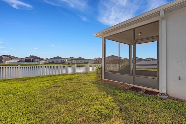 6211 114th Dr E, Parrish, FL 34219 - view of yard with a residential view, a water view, and a sunroom