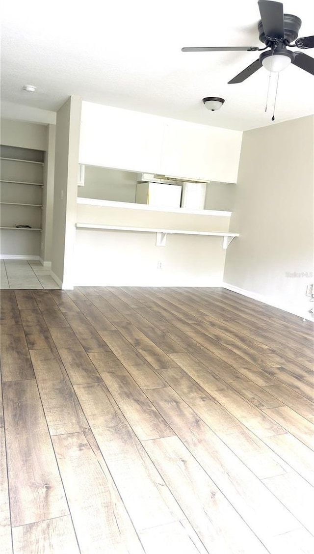 2302 Maki Rd Unit 69, Plant City, FL 33563 - unfurnished living room featuring wood finished floors, a ceiling fan, and built in features