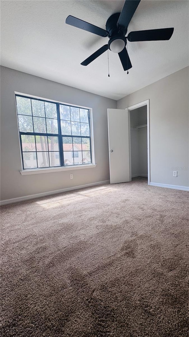 2302 Maki Rd Unit 69, Plant City, FL 33563 - unfurnished bedroom with carpet, baseboards, a closet, and a ceiling fan